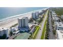 Aerial view of beachfront property with tennis courts at 5207 S Atlantic Ave # 626, New Smyrna Beach, FL 32169