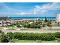 Residential beachfront neighborhood view with palm trees, lush greenery, and ocean views at 5300 S Atlantic Ave # 3-504, New Smyrna Beach, FL 32169