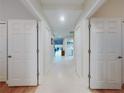 Hallway leading to various rooms, with neutral walls and tile flooring for a clean and bright aesthetic at 5300 S Atlantic Ave # 3-504, New Smyrna Beach, FL 32169