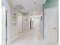 Bright hallway featuring white doors, modern lighting, and stylish decor at 5300 S Atlantic Ave # 3-504, New Smyrna Beach, FL 32169