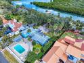 Overhead angle showing the property's pool, spacious yard, and position in the neighborhood by the waterway at 634 N Riverside Dr, New Smyrna Beach, FL 32168