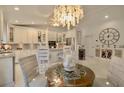 Bright white kitchen with granite counters, island, and breakfast nook at 6345 River Rd, New Smyrna Beach, FL 32169