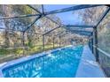 Inviting, screened-in pool perfect for relaxation at 735 S Glencoe Rd, New Smyrna Beach, FL 32168