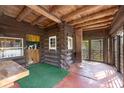 Cozy screened-in porch with rustic wood details at 735 S Glencoe Rd, New Smyrna Beach, FL 32168