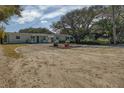 Charming home with a gravel driveway and a cozy front porch, perfect for relaxing outdoors at 817 E 12Th Ave, New Smyrna Beach, FL 32169