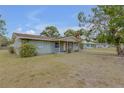 Light green house with a covered porch and yard at 904 Wilkins St, New Smyrna Beach, FL 32168