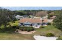 Aerial shot of the rear of the home, showcasing the patio, manicured yard, and beautiful surroundings at 958 Beach Fern Ct, New Smyrna Beach, FL 32168