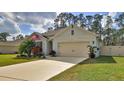Beautiful single-story home features well-kept lawn, neutral paint, and a spacious driveway leading to a two-car garage at 114 Sunset Point Dr, Ormond Beach, FL 32174