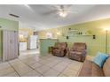 Inviting living room with tile flooring, ceiling fan, and a cozy seating area at 118 Orange Ave, Edgewater, FL 32132