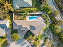 Aerial view of a single Gathering home with a pristine pool and well-manicured yard at 13 Arena Blanca, Ponce Inlet, FL 32127