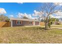 Charming single-story home showcasing a well-maintained lawn, newer fence, and inviting curb appeal at 1935 Fern Palm Dr, Edgewater, FL 32141