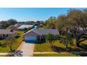 Aerial view of a beautiful brick home with a well-manicured lawn and a two-car garage at 234 Meadow Lake Dr, Edgewater, FL 32141