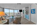 Comfortable living room with floor-to-ceiling windows and access to a private balcony at 2625 S Atlantic Ave # 11Nw, Daytona Beach, FL 32118