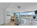 This condo features floor-to-ceiling windows, light wood flooring, and a comfortable seating area at 2625 S Atlantic Ave # 11Nw, Daytona Beach, FL 32118