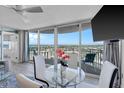 Condo living room with floor to ceiling windows, dining table, and access to an outdoor balcony at 2625 S Atlantic Ave # 11Nw, Daytona Beach, FL 32118
