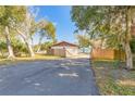 View of the backyard with wooden fence and access road at 3003 Tamarind Dr, Edgewater, FL 32141