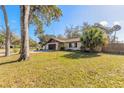 Beautiful single-Gathering home with a well-manicured lawn and mature landscaping at 3003 Tamarind Dr, Edgewater, FL 32141