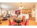 Open concept dining area with glass table, stylish chairs, and views into the kitchen and living space at 3456 Pegaso Ave, New Smyrna Beach, FL 32168