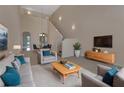 Staged living room featuring high ceilings, carpet, and neutral-colored furniture at 3546 Casalta Cir, New Smyrna Beach, FL 32168