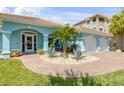 Beautiful turquoise home with an attached two car garage and lovely xeriscaping at 3728 Egret Dunes Dr, Ormond Beach, FL 32176