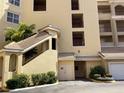 Elegant condo building with multiple floors, balconies, and well-maintained landscaping at 424 Luna Bella Ln # 226, New Smyrna Beach, FL 32168