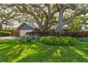Lovely single Gathering home with a two car garage and a lush front yard with mature trees at 4426 Saxon Dr, New Smyrna Beach, FL 32169