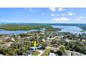 An aerial view showcases the coastal home's waterfront location and beautiful green surroundings at 61 E Bayshore Dr, Port Orange, FL 32127