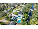 An aerial view of the neighborhood shows the turquoise home's pool and the nearby canal at 61 E Bayshore Dr, Port Orange, FL 32127
