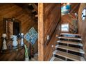 Charming entryway with wood paneling, tiled steps, and nautical decorations creates a coastal welcome at 6531 Turtlemound Rd, New Smyrna Beach, FL 32169