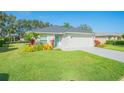 Lush front lawn and landscape beds adorn this beautiful single-story home with an attached garage at 662 Wellesley Ct, New Smyrna Beach, FL 32168