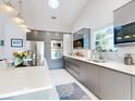 Modern kitchen featuring gray cabinets, stainless steel appliances, a large island and lots of natural light at 751 Pine Shores Cir, New Smyrna Beach, FL 32168