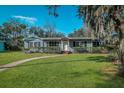 Charming single-story home with a well-manicured lawn and inviting walkway at 820 Faulkner St, New Smyrna Beach, FL 32168