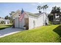 Exterior side view of home showing well-maintained lawn and charming architectural details at 848 Pine Shores Cir, New Smyrna Beach, FL 32168