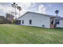 Exterior view of home showing well-maintained lawn, screened porch, and access to the garden at 848 Pine Shores Cir, New Smyrna Beach, FL 32168
