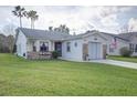 Charming single-story home featuring a well-maintained lawn, brick accents, and an attached two-car garage at 848 Pine Shores Cir, New Smyrna Beach, FL 32168