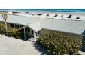 Elevated view of the house, lush greenery, and private beach access at 921 N Atlantic Ave, New Smyrna Beach, FL 32169