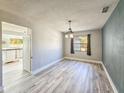 This dining room is bright with an interesting chandelier at 950 Sand Crest Dr, Port Orange, FL 32127