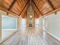 Spacious living room boasts a stone fireplace and wood ceiling at 950 Sand Crest Dr, Port Orange, FL 32127