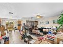 Spacious living area with tile flooring, a ceiling fan, and ample natural light, with some boxes at 1043 Beulah Dr, Edgewater, FL 32132