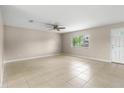 Spacious living room with neutral walls, tile floors, and a window providing ample natural light at 1043 Beulah Dr, Edgewater, FL 32132
