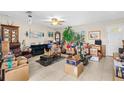 Inviting living room with tile floors, lots of moving boxes, and a cozy seating area at 1043 Beulah Dr, Edgewater, FL 32132