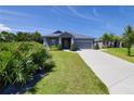 Well maintained single-story home with driveway and manicured lawn at 1100 Loch Linnhe Ct, New Smyrna Beach, FL 32168