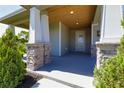 Inviting front porch features stone accents and wood plank ceiling at 1100 Loch Linnhe Ct, New Smyrna Beach, FL 32168