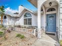 Inviting home entrance with a stylish blue front door and decorative stone accents at 1175 Margina Ave, Daytona Beach, FL 32114