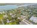 Wide aerial shot of the neighborhood with the property highlighted near the water at 118 E Palm Way, Edgewater, FL 32132