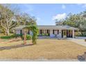 Charming home exterior featuring a well-maintained lawn and inviting entryway trellis at 128 Dixwood Ave, Edgewater, FL 32132