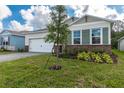 Attractive single-story home with green shutters, brick accents, a paved driveway, and landscaped front yard at 1731 Red Rock Rd, New Smyrna Beach, FL 32168