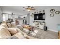 Open-concept living room with seamless flow to the modern kitchen and dining area at 1855 Needle Palm Dr, Edgewater, FL 32141