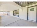 Welcoming covered entry with decorative door, large window, and access to a screened in lanai at 2509 Milton Ave, New Smyrna Beach, FL 32168