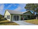 Charming single-story home with a well-manicured lawn, sliding door access, and a classic look at 26 Birdie Dr, New Smyrna Beach, FL 32168